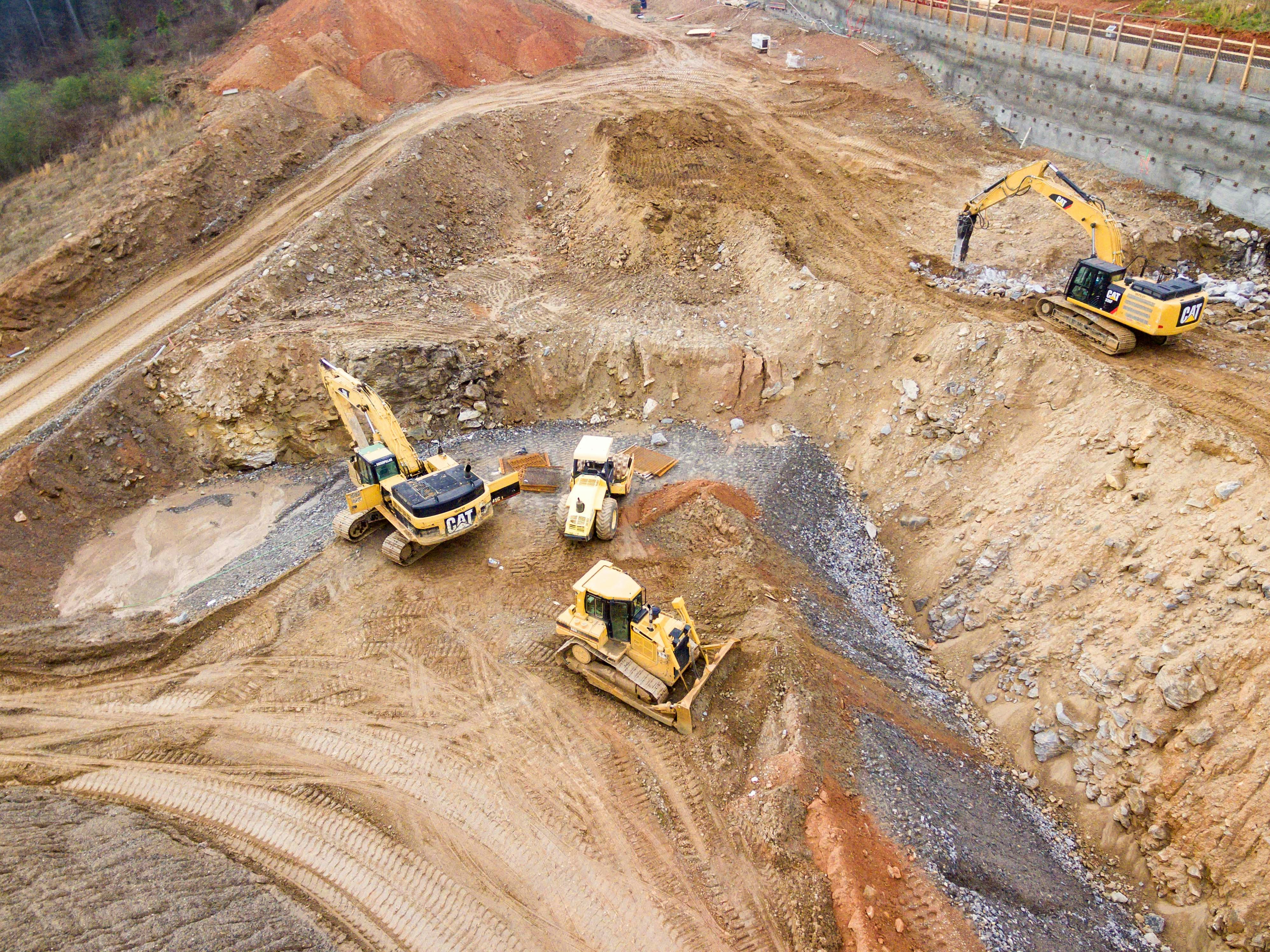 Aerial view of excavators and a bulldozer on an active earthwork site